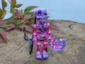 Movable Skeleton Cover Minder - Purple/Pink